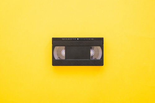 photograph of a vhs tape on a yellow background
